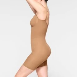 SEAMLESS SCULPT MID THIGH BODYSUIT | OCHRE -SWIM Sales Store SKIMS SHAPEWEAR BD MDT 3372 IE OCH 0010 SD 30824057 658e 4d3b b2db 85235c3503b5