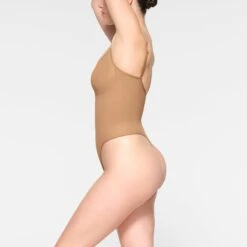 SEAMLESS SCULPT THONG BODYSUIT | OCHRE -SWIM Sales Store SKIMS SHAPEWEAR BD THG 3369 IE OCH 0011 SD 76a2fe87 3ad9 451e b0be f0ff72044119